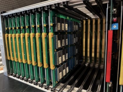 A row of ten memory cards with yellow handles, inserted vertically, then five empty slots