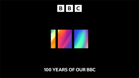 White BBC logo and 100 YEARS OF OUR BBC lettering with a 100 represented by one thin and two thick, rainbow-coloured rectangles side by side (16K)