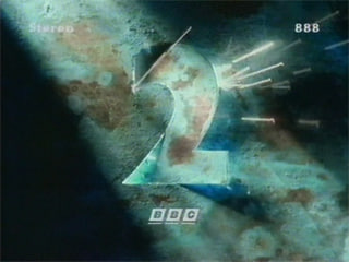 A copper surface with a patchy, green patina has a 2-shaped door in it that is slightly ajar. Sparks are flying through the gap.  (17K)