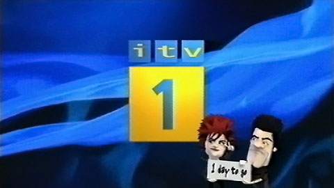 ITV1 ident with caricatures of The X Factor judges Sharon Osbourne and Simon Cowell carrying a placard with '1 day to go' written on it (22K)