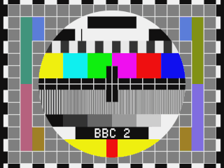 Test Card G with BBC2 legend, a background of grey squares and a circle containing colour bars, frequency gratings